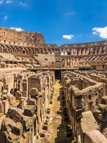 Inside the Colosseum, an amphitheater located in Ancient Rome.
614830518
Lazio, Color Image, Travel Destinations, Horizontal, Panoramic, Famous Place, Photography, Amphitheater, Rome - Italy, Italy, Capital Cities, Roman, Coliseum - Rome, Europe, Monument, Old Ruin, Built Structure, Indoors, Ruin, Innovation, Rome
