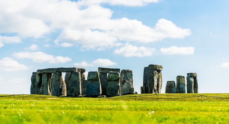 Wide view of stones at Stonehenge. Stonehenge is a prehistoric monument in Wiltshire, England and consists of a ring of standing stones. Beautiful Stonehenge wish blue sky.
