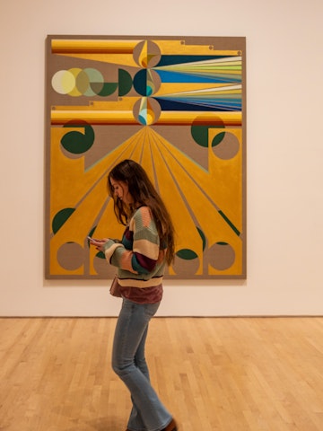 SAN FRANCISCO, USA - December 8, 2019, visitors are similar in color to the artifacts in question at the California Museum of Modern Art, a girl walks past the picture.; Shutterstock ID 1622086819; your: Meghan O'Dea; gl: 65050; netsuite: Online Editorial; full: POI page